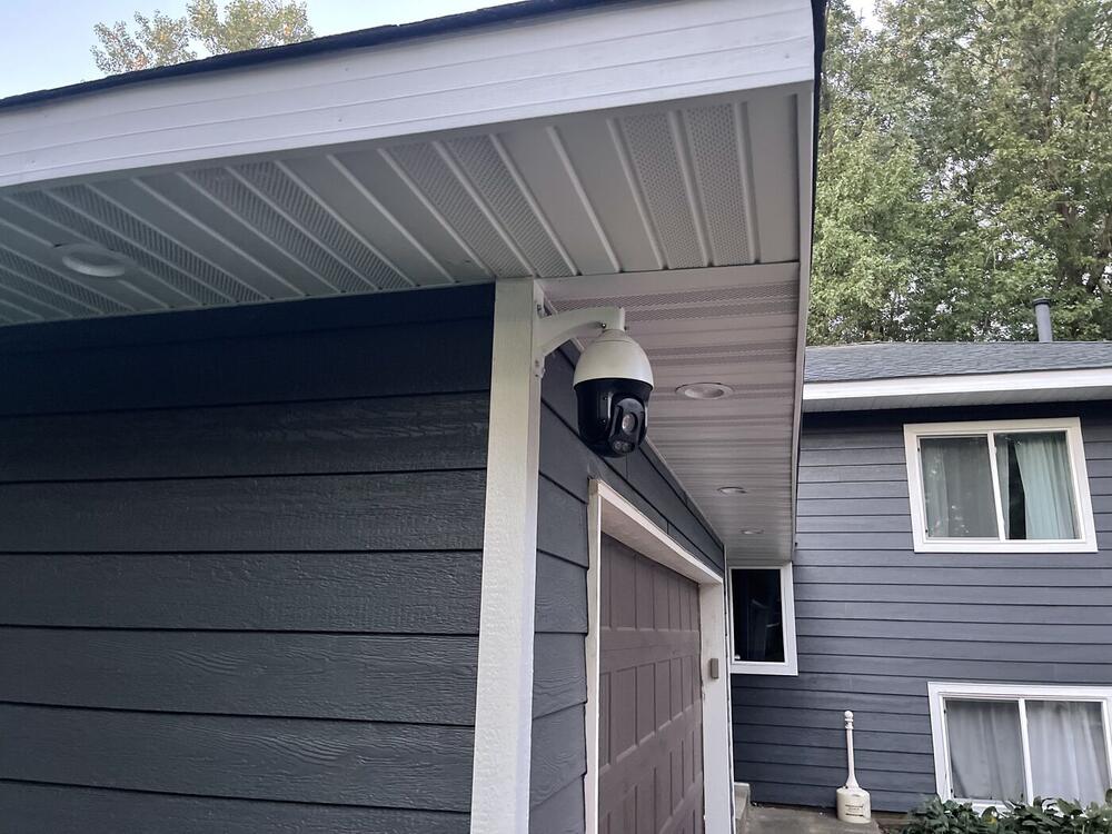 UniFi PTZ security camera mounted on a home